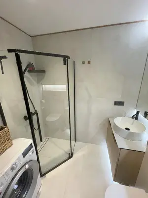 a bathroom with a shower and a toilet and a sink at Jaukus butas miesto centre in Šiauliai