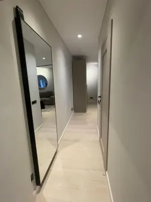 a hallway with two mirrors on the walls at Jaukus butas miesto centre in Šiauliai