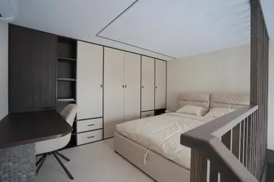 a bedroom with a bed and a desk in it at K32 Loft in Vilnius