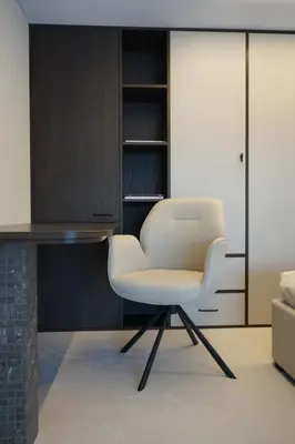 a white chair in a room with a desk at K32 Loft in Vilnius