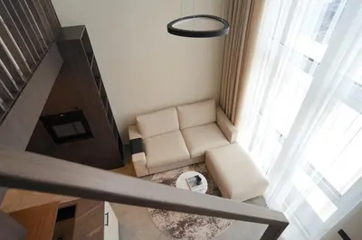 a living room with a white couch and a window at K32 Loft in Vilnius