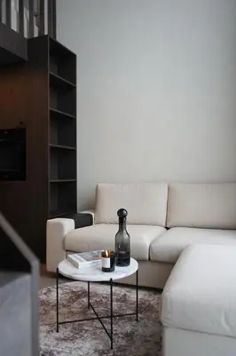 a living room with a white couch and a table at K32 Loft in Vilnius