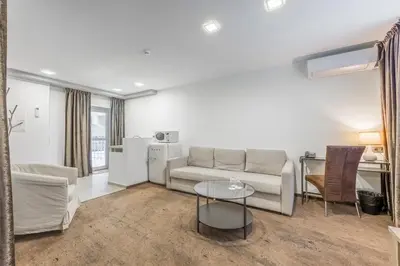 a living room with a couch and a table at HOF Apartments in Kaunas