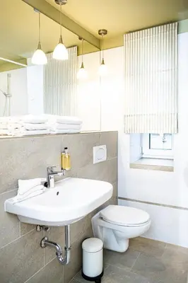 a bathroom with a sink and a toilet at HOF Apartments in Kaunas