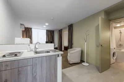 a bathroom with a sink and a toilet at HOF Apartments in Kaunas