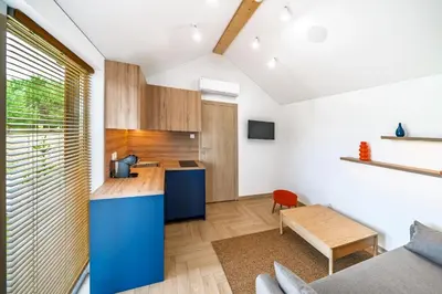 a kitchen with a blue island in a room at Nemunas Glamping in Kriemala