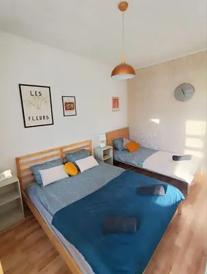two beds in a bedroom with blue and white at 2 Bedrooms Apartment Vilnius Center in Vilnius