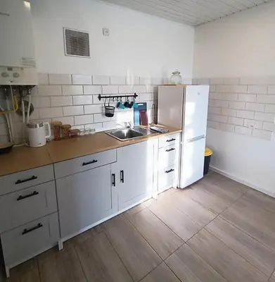 a kitchen with a white refrigerator and a sink at 2 Bedrooms Apartment Vilnius Center in Vilnius