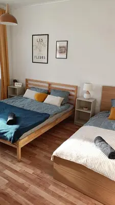 a bedroom with two beds and two night stands at 2 Bedrooms Apartment Vilnius Center in Vilnius