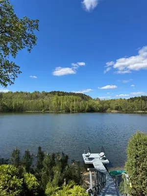 a boat on a dock on a lake at Dream Vila Trakai in Trakai