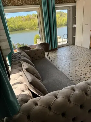 a living room with a couch and a large window at Dream Vila Trakai in Trakai
