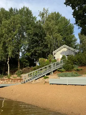 a bridge over the water in front of a house at Dream Vila Trakai in Trakai
