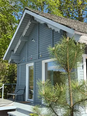 a tiny house with a large window on a deck at Dream Vila Trakai in Trakai