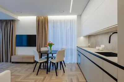 a kitchen and dining room with a table and chairs at Nemunaičiai Relax in Kaunas