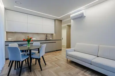 a living room with a couch and a table and chairs at Nemunaičiai Relax in Kaunas