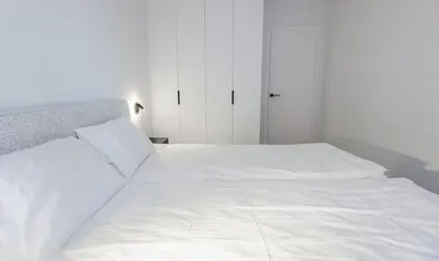 a large white bed in a white bedroom at Nemunaičiai Relax in Kaunas