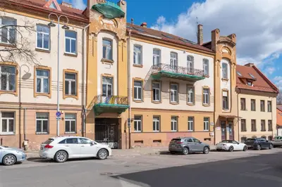 a group of cars parked in front of a building at Apartments in the old town in Vilnius