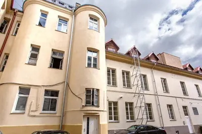 a large tan building with a lot of windows at Apartments in the old town in Vilnius
