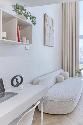 a white living room with a couch and a table at Sunny loft 2 x 24x7 x Free parking x Close to old town in Vilnius