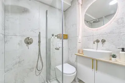 a bathroom with a shower and a toilet and a sink at Sunny loft 2 x 24x7 x Free parking x Close to old town in Vilnius