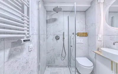 a bathroom with a shower with a toilet and a sink at Sunny loft 2 x 24x7 x Free parking x Close to old town in Vilnius