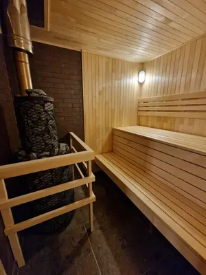 a sauna with two wooden benches in a room at Atostogų namelis SAMANOTA PAMIŠKĖ, pirtis ir kubilas papildomai in Romaškiai