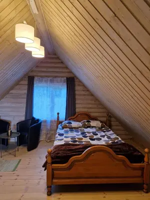 a bedroom with a bed in a attic at Atostogų namelis SAMANOTA PAMIŠKĖ, pirtis ir kubilas papildomai in Romaškiai