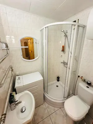 a bathroom with a toilet and a shower and a sink at SUN CITY Varpo Apartment in Šiauliai
