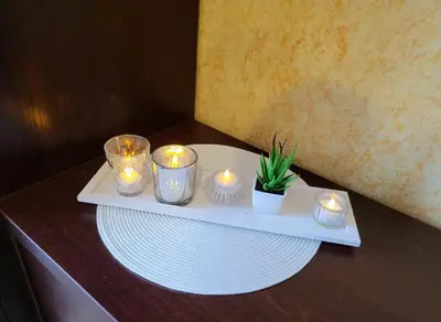 a tray with candles and a plate on a table at SUN CITY Varpo Apartment in Šiauliai