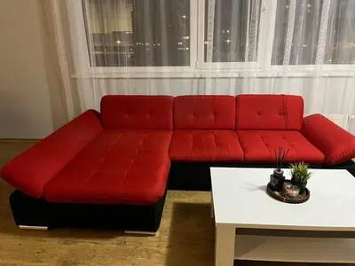 a red couch in a living room with a table at Holiday Home in Druskininkai