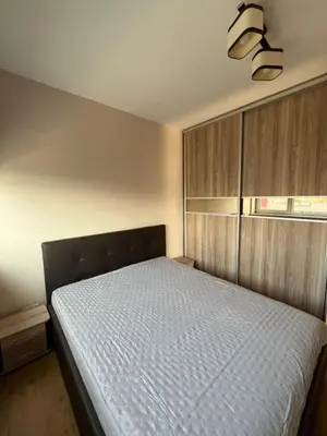 a bedroom with a bed with a white bedspread at Holiday Home in Druskininkai