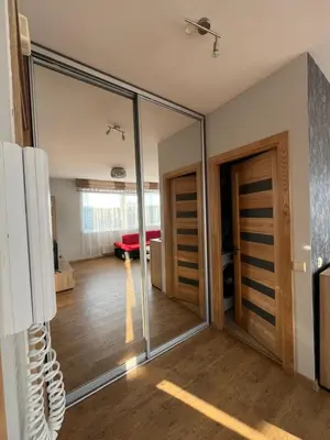 a room with sliding glass doors and a living room at Holiday Home in Druskininkai