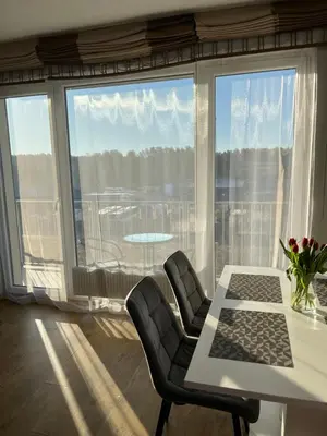 a room with a table and chairs and a large window at Holiday Home in Druskininkai