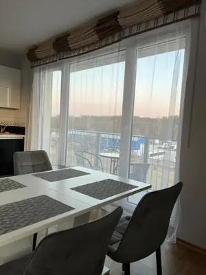 a kitchen with a table and chairs and a large window at Holiday Home in Druskininkai