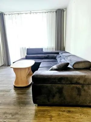 a living room with a couch and a table at Cozy Corner in Šiauliai