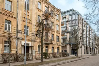 a row of tall brick buildings on a street at Cozy 2-Bedroom Apartment - 4 in Vilnius