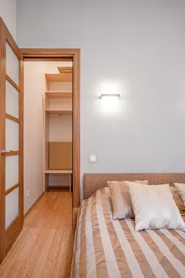 a bedroom with a bed and a closet at Cozy 2-Bedroom Apartment - 4 in Vilnius