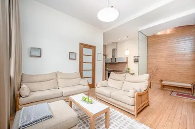 a living room with two couches and a table at Cozy 2-Bedroom Apartment - 4 in Vilnius