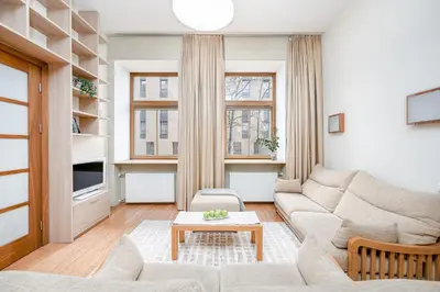 a living room with a couch and a table at Cozy 2-Bedroom Apartment - 4 in Vilnius