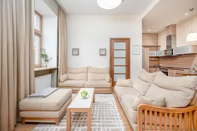 a living room with a couch and a table at Cozy 2-Bedroom Apartment - 4 in Vilnius
