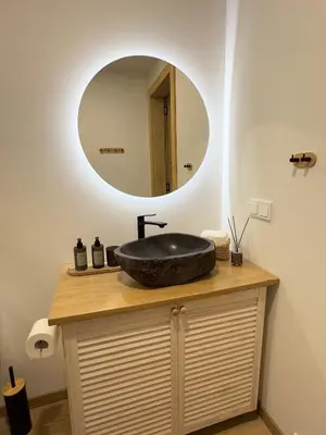 a bathroom with a black sink and a mirror at MOSS lodge in Naujasėdžiai