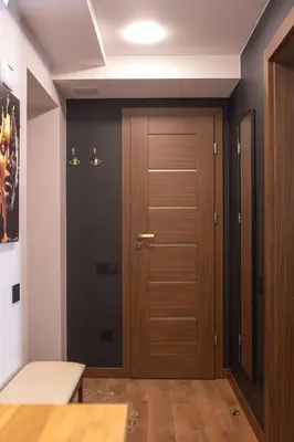 a hallway with a wooden door in a house at Euforia - Jacuzzi apartment Ukmergė in Ukmergė