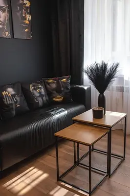 a living room with a leather couch and a table at Euforia - Jacuzzi apartment Ukmergė in Ukmergė