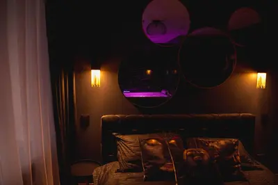a room with a couch and a mirror on the wall at Euforia - Jacuzzi apartment Ukmergė in Ukmergė