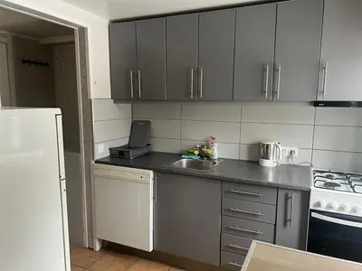 a small kitchen with a sink and a stove at Small house in Vilnius