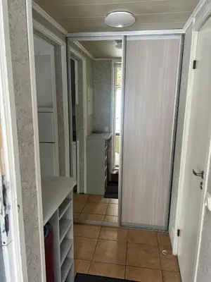 a hallway with a door leading to a kitchen at Small house in Vilnius