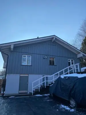 a house with a front porch and a garage at Small house in Vilnius