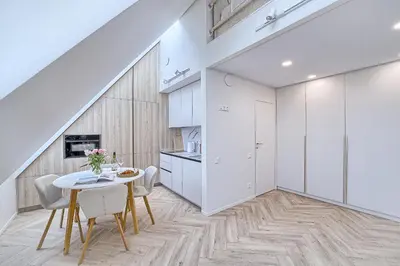a kitchen and dining room with a table and chairs at Amazing apartments 2 x free parking x 24x7 in Vilnius