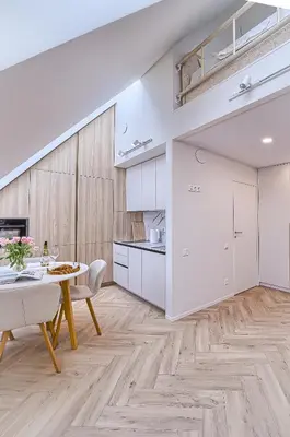 an open kitchen and dining room with a table and chairs at Amazing apartments 2 x free parking x 24x7 in Vilnius