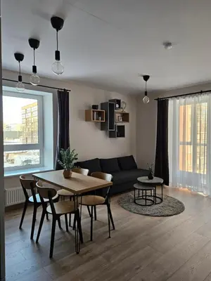 a living room with a table and a couch at Vilniaus apartamentai in Vilnius